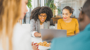 Two women looking at a laptop screen