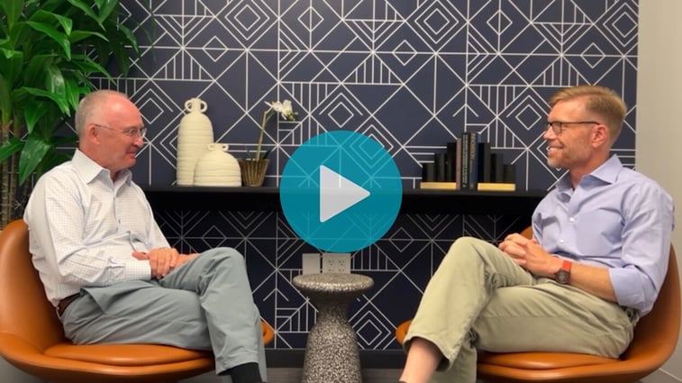 Screenshot of a video with Peter Gibbons and Alex Bombeck