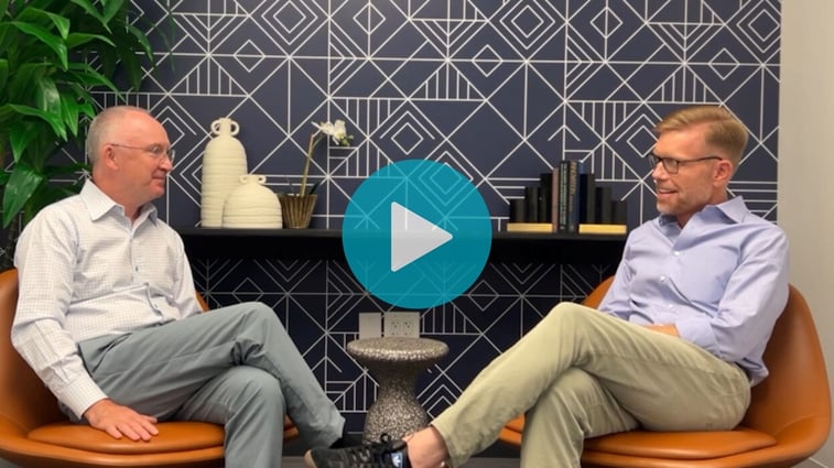 Screenshot of a video with Peter Gibbons and Alex Bombeck