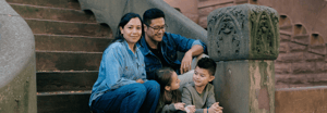 A family of four sitting on a stoop