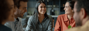Five people smiling around a table