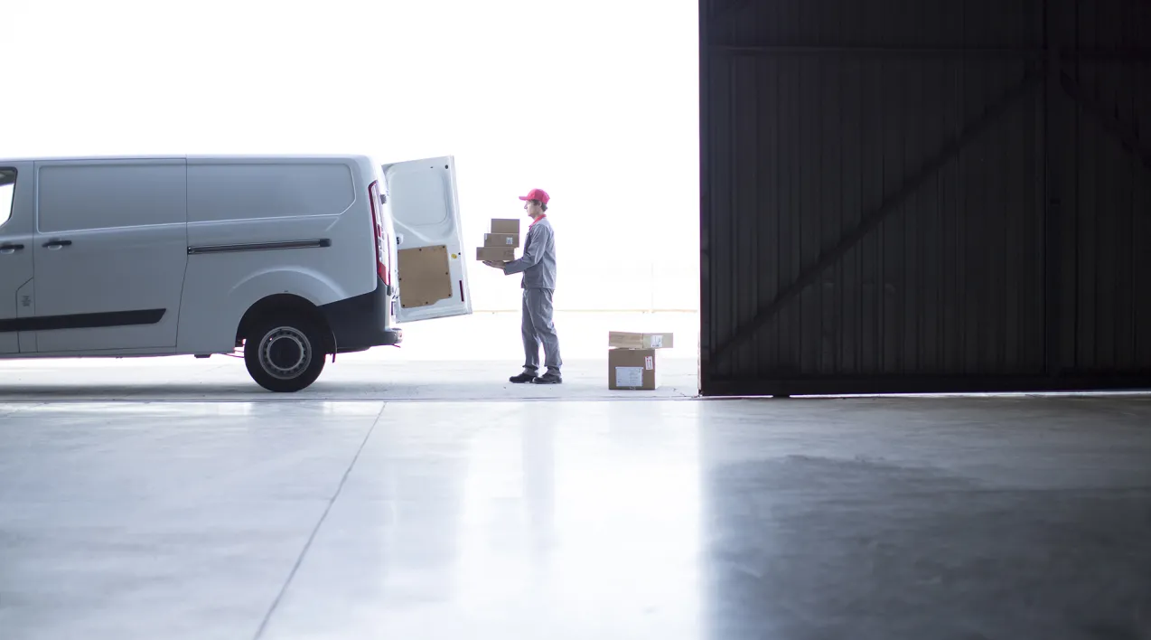 A logistics employee loads a truck.